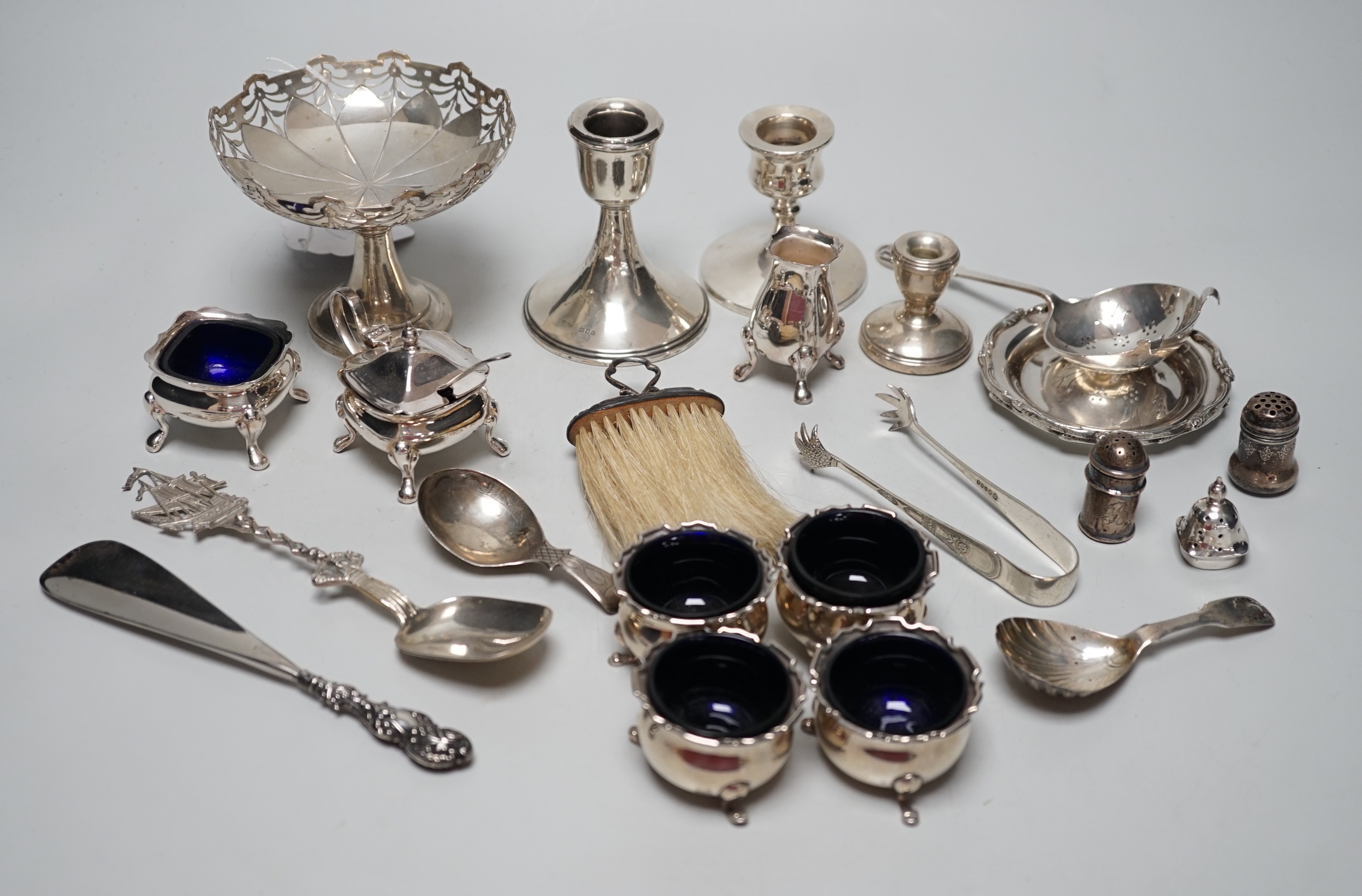 Sundry small silver including four salts by Mappin & Webb, three mounted dwarf candlesticks, two white metal Egyptian dishes and a white metal tazza, eight other items including two 19th century caddy spoons and four pla